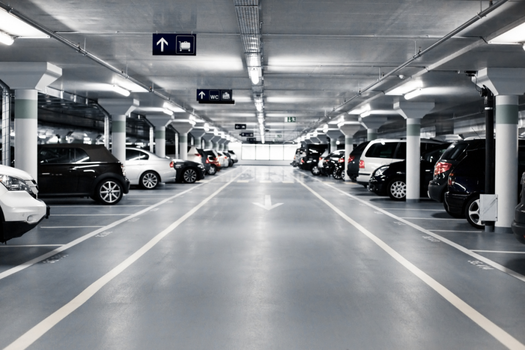 Clean indoor digital parking garage with smart sensors and real-time availability indicators.