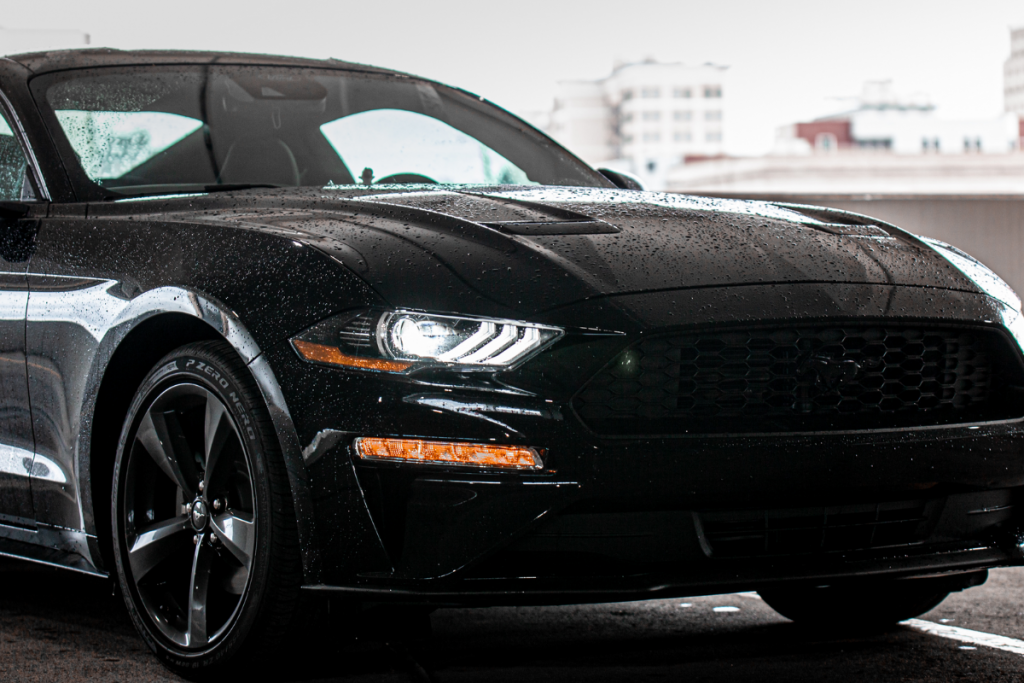 Front of a black sleek sportscar representing license plate recognition (LPR) enabled parking solutions