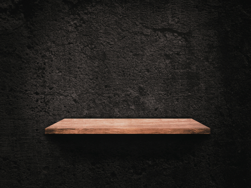 Empty shelf on a black wall symbolizing limited innovation and rigid off-the-shelf software.